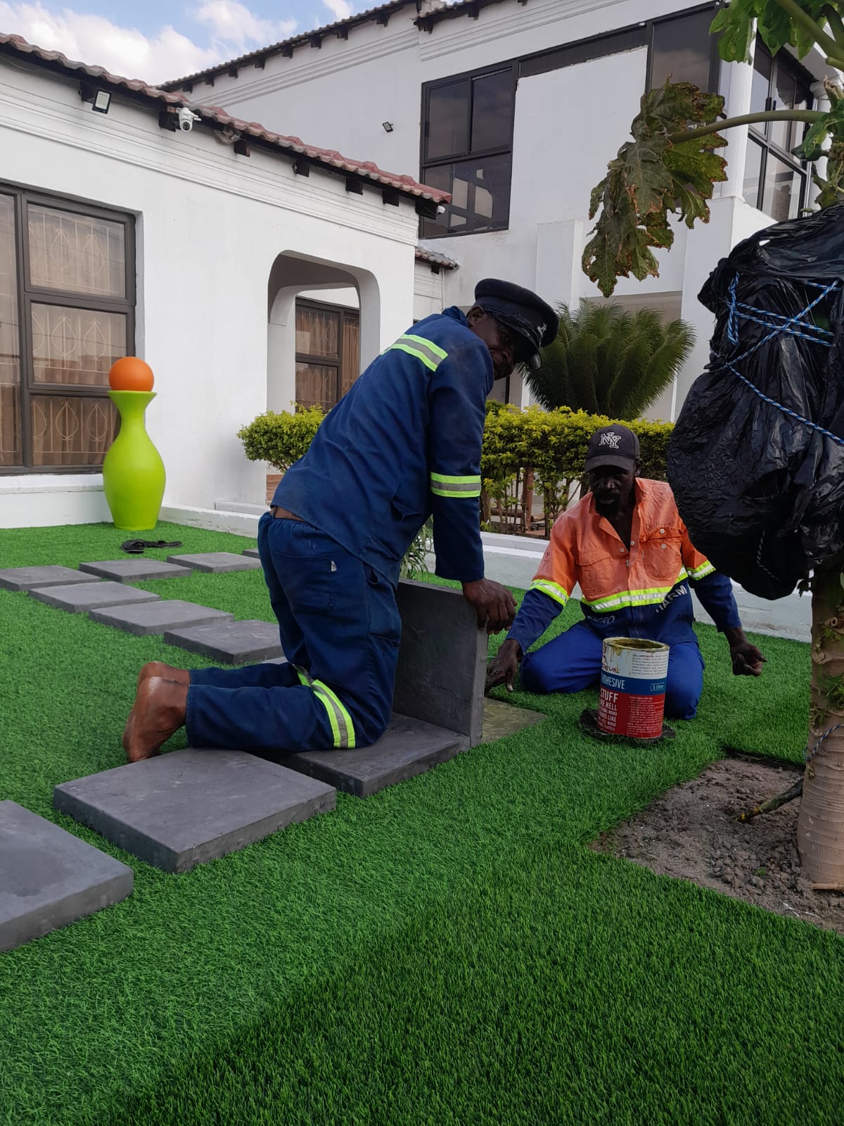 Lush artificial lawn in backyard